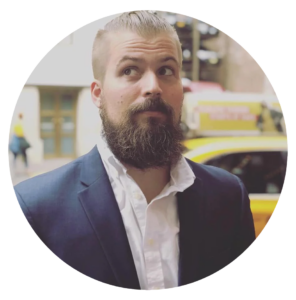 An image of Jonathan Tomick wearing a navy blue suit
