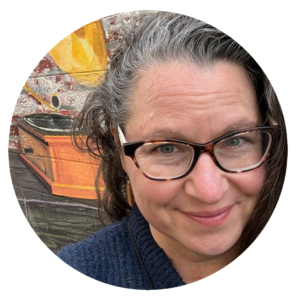 An image of Meri Robie wearing tortoise-shell pattern glasses