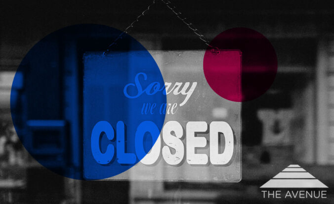 Sign on a window with text "Sorry, we're closed."